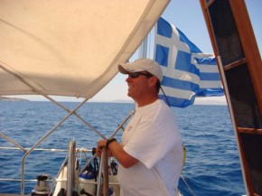 man piloting a sailing boat